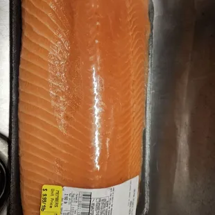 a salmon fillet in a stainless steel sink