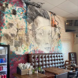 a mural of a woman&apos;s face on the wall