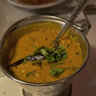 a bowl of soup with a spoon in it