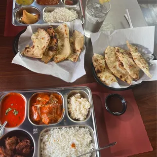 lentil and tomato soup, vegetable samosa, chicken masala and curry, garlic naan, onion Bhaji, rice pudding (kheer), gulab jamun