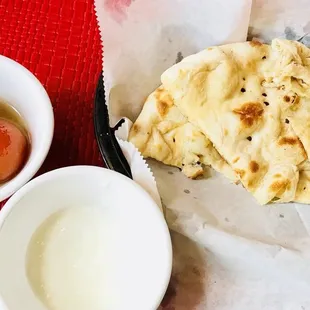 a bowl of yogurt and pita bread
