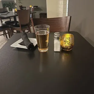 a glass of beer and salt on a table