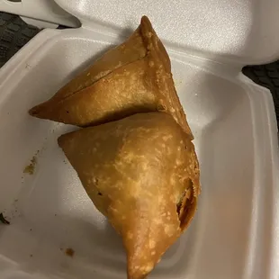 two pastries in a styrofoam container