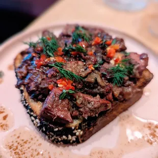 Chopped chicken liver with oyster mushrooms, vinegar, capers, brown butter and cardamom served over challah.