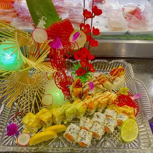 a platter of sushi and vegetables