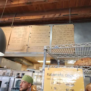 a man standing in front of a display of baked goods
