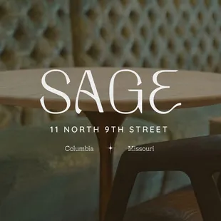 a table and chairs in front of a wall