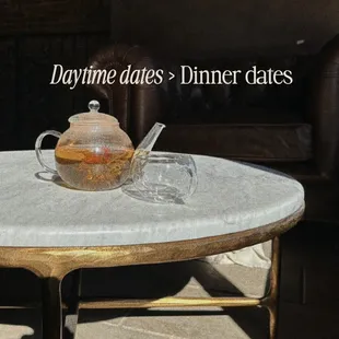 a glass teapot on a table with a glass teapot on it