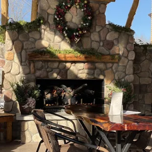outdoor dining area with fireplace