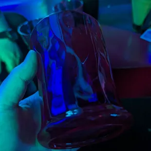 a hand holding a blue glass