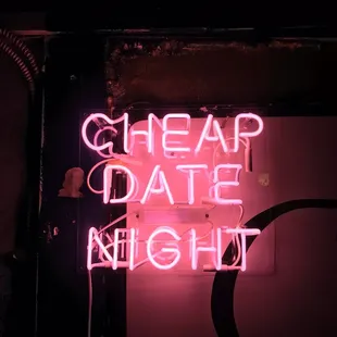 a neon sign that says cheap date night
