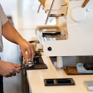 a person using a coffee grinder