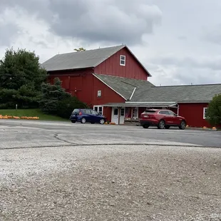 a red barn and a blue truck