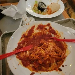 a dirty plate of food on a tray