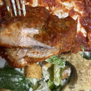 Undercooked pink chicken in their chicken parm.