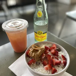 Green tea grapefruit iced drink, topo Chico, açaí bowl with GF granola, coconut, strawberries and peanut butter.