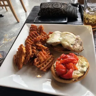Pesto chicken sandwich with sweet potato fries.