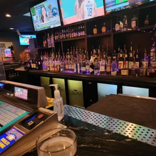 a beer in a pint glass at a bar