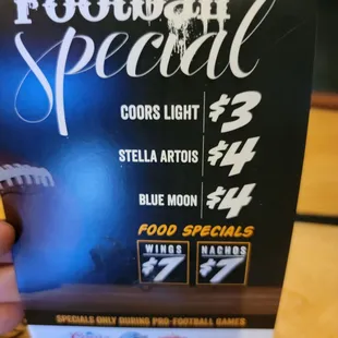 a hand holding a football special menu