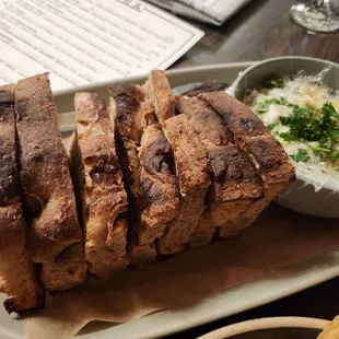 a loaf of bread and a bowl of gravy