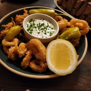 a plate of fried squids and a bowl of dip