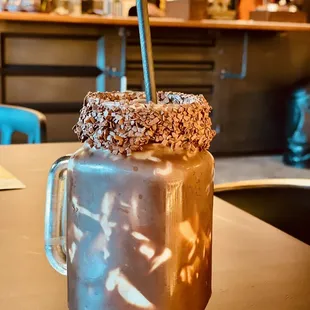 a chocolate milkshake with sprinkles on top