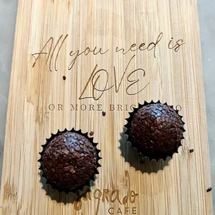 two chocolate cupcakes on a cutting board