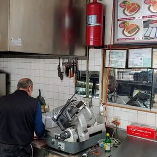 The owner making my Basturama sandwich.