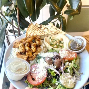 a person holding a plate of food