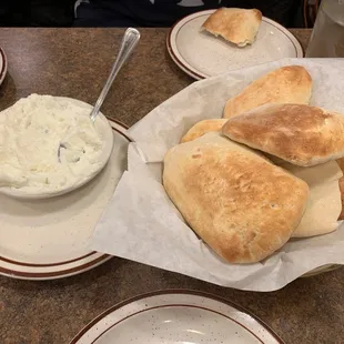 a plate of pita bread and a bowl of dip