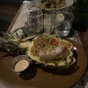 Mahi Mahi on a bed of fried rice on pineapple