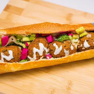 a meatball sandwich on a cutting board