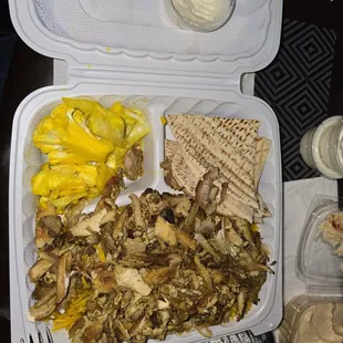 Chicken shawarma plate with hummus, pickle vegetables and a side of garlic sauce