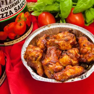 a bowl of chicken wings and tomatoes