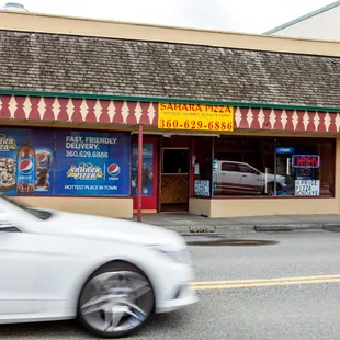 a white car passing by