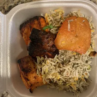 Dill rice, with chunks of salmon peace's, grilled, with potato, witch comes of the bottom of the pot, called potato tadiegg.