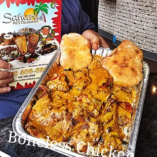 a person holding a tray of food