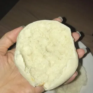 a person holding a sandwich on a plate