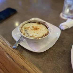 a cup of soup on a plate