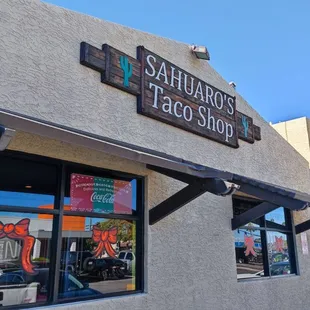 The sign, from outside the taco shop.