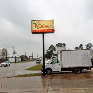 a delivery truck parked in front of a restaurant