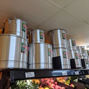 a variety of metal pots and pans on a shelf