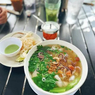 a bowl of soup and a plate of noodles