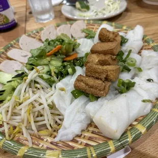 Banh Cuon with tofu. The other versions would have the meat stuffed inside, whereas the tofu is on top.