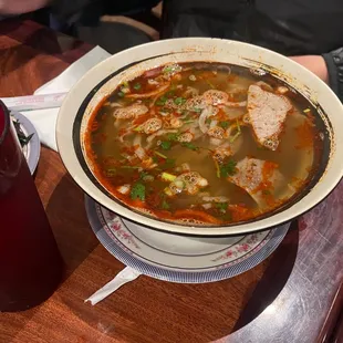 a bowl of soup with meat and vegetables