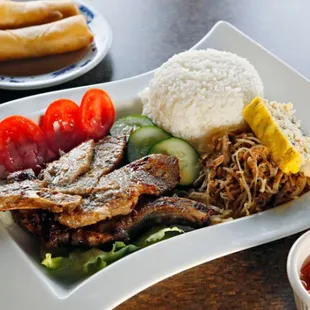 a plate of meat, rice, and vegetables
