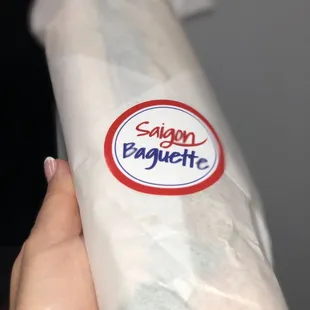 a person holding a baguette