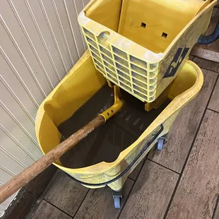 Dirty mop bucket water in plain view in dining area. Not the first time this was here with dirty water.