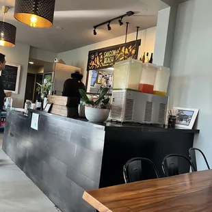 a restaurant counter with a person standing at the counter