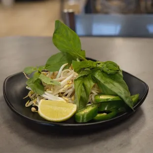 a plate of food with a lemon wedge